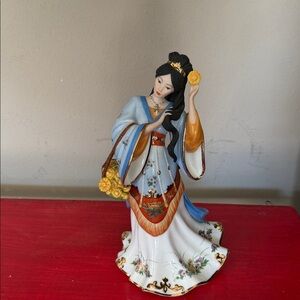 Elegant Porcelain Figurine with Blue and Orange Accents